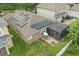 Aerial shot of a home with solar panels, screened-in patio, and a large backyard with play equipment at 15038 Masthead Landing Cir, Winter Garden, FL 34787