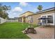 Large backyard with lush green grass, a patio, a playset, and a charming picnic table, perfect for Gathering fun at 15038 Masthead Landing Cir, Winter Garden, FL 34787