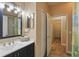 Bright bathroom with vanity, sink, and an open doorway to the hallway at 15038 Masthead Landing Cir, Winter Garden, FL 34787