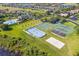 Aerial view of the community courts, beach volleyball and pool areas, surrounded by mature trees at 15038 Masthead Landing Cir, Winter Garden, FL 34787