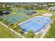 Overhead view of community sports courts with hockey rink, basketball and tennis courts with parking at 15038 Masthead Landing Cir, Winter Garden, FL 34787