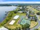 Beautiful aerial view of a Gathering-friendly community with a pool, a lake and several sports courts at 15038 Masthead Landing Cir, Winter Garden, FL 34787