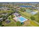 Gorgeous aerial shot of community amenities including the pool, clubhouse, tennis courts, and pond at 15038 Masthead Landing Cir, Winter Garden, FL 34787