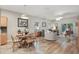 Open dining area featuring a round wooden table and chairs adjacent to a living room with great lighting at 15038 Masthead Landing Cir, Winter Garden, FL 34787