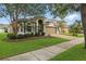 Inviting two-story home with well-maintained landscaping, brick driveway, mature trees, and a two-car garage at 15038 Masthead Landing Cir, Winter Garden, FL 34787