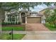Charming single-Gathering home featuring a brick driveway, a well-maintained lawn, and a two-car garage at 15038 Masthead Landing Cir, Winter Garden, FL 34787