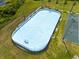 Aerial view of the community ice rink and a tennis court surrounded by manicured lawns at 15038 Masthead Landing Cir, Winter Garden, FL 34787