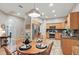 Kitchen with a view of the dining area featuring granite counters, stainless appliances, and wood cabinets at 15038 Masthead Landing Cir, Winter Garden, FL 34787
