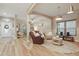 Open-concept living room with wood flooring, archways, neutral paint, and plenty of natural light at 15038 Masthead Landing Cir, Winter Garden, FL 34787