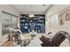Cozy living room with blue bookcase, stylish chairs, and ample natural light from the window at 15038 Masthead Landing Cir, Winter Garden, FL 34787