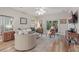 Bright living room featuring hardwood floors, comfortable seating, and sliding glass doors to the outdoors at 15038 Masthead Landing Cir, Winter Garden, FL 34787