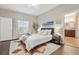 Bright main bedroom with hardwood floors, natural light, and ensuite bathroom access at 15038 Masthead Landing Cir, Winter Garden, FL 34787
