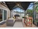 Outdoor screened patio featuring comfortable seating, a grill, and a decorative rug, perfect for relaxation at 15038 Masthead Landing Cir, Winter Garden, FL 34787