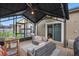 Relaxing screened patio with cozy outdoor seating, brick flooring, and covered shelter, ideal for outdoor enjoyment at 15038 Masthead Landing Cir, Winter Garden, FL 34787