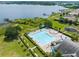 Aerial view of the community pool, surrounded by lush landscaping and overlooking the lake at 15038 Masthead Landing Cir, Winter Garden, FL 34787