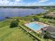 Aerial view of a community pool and clubhouse with meticulously maintained landscaping near the lake at 15038 Masthead Landing Cir, Winter Garden, FL 34787