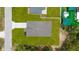 Overhead view of a single-story home with a paved driveway and a well-manicured lawn at 16357 Se 88Th Ct, Summerfield, FL 34491
