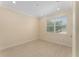 Empty bedroom with window for natural light, neutral walls, and tile floors at 16357 Se 88Th Ct, Summerfield, FL 34491