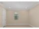 Cozy bedroom with bright window, light paint, and tile floors creating a comfortable and tranquil setting at 16357 Se 88Th Ct, Summerfield, FL 34491