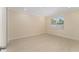 Light-filled bedroom with window view, neutral paint, and tile floors providing a serene and inviting space at 16357 Se 88Th Ct, Summerfield, FL 34491