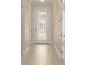 Bright hallway features a patterned front door and tiled floors leading to rooms with white paneled doors at 16357 Se 88Th Ct, Summerfield, FL 34491