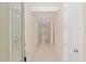 Bright hallway featuring neutral paint, tiled floors, and paneled doors at 16357 Se 88Th Ct, Summerfield, FL 34491