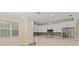Bright kitchen with white cabinetry, stainless steel appliances, and a center island, blending style and functionality at 16357 Se 88Th Ct, Summerfield, FL 34491