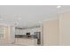 Open kitchen with stainless steel appliances, white cabinets, and stone countertops provides a modern space at 16357 Se 88Th Ct, Summerfield, FL 34491