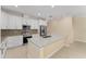 Well-equipped kitchen featuring white cabinets, granite countertops, stainless steel appliances, and a central island at 16357 Se 88Th Ct, Summerfield, FL 34491