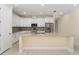 Modern kitchen featuring white cabinetry, stainless steel appliances, and an island with a granite countertop at 16357 Se 88Th Ct, Summerfield, FL 34491