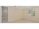 Cozy room featuring neutral walls, tile flooring, a window, and a doorway leading to another room at 16357 Se 88Th Ct, Summerfield, FL 34491