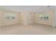 Bright, empty room featuring tile flooring, neutral walls, and windows, offering a versatile living space at 16357 Se 88Th Ct, Summerfield, FL 34491