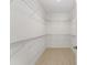 Organized walk-in closet with shelving for ample storage space offers practicality and convenience at 16357 Se 88Th Ct, Summerfield, FL 34491