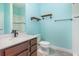Bright bathroom featuring a quartz countertop, a modern faucet, and decorative wood shelves at 17044 Goldcrest Loop, Clermont, FL 34714