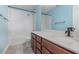 Bathroom with a white tiled shower/tub and brown vanity with a quartz countertop at 17044 Goldcrest Loop, Clermont, FL 34714
