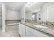 Bathroom featuring a granite countertop, white cabinets and tile flooring, and a soaking tub at 17044 Goldcrest Loop, Clermont, FL 34714