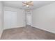 Spacious bedroom with neutral carpet, ceiling fan, and walk-in closet at 17044 Goldcrest Loop, Clermont, FL 34714