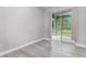 Bedroom featuring wood-look floors and sliding door to a patio at 17044 Goldcrest Loop, Clermont, FL 34714