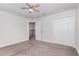 Bedroom featuring neutral carpet, ceiling fan, and access to the second floor at 17044 Goldcrest Loop, Clermont, FL 34714