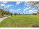 Community green space featuring a walking path, manicured lawn, and bench seating at 17044 Goldcrest Loop, Clermont, FL 34714