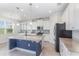 Modern kitchen featuring white cabinets, stainless steel appliances, and a center island at 17044 Goldcrest Loop, Clermont, FL 34714