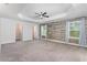 Large primary bedroom with a ceiling fan, and a decorative wood accent wall at 17044 Goldcrest Loop, Clermont, FL 34714