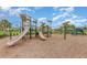 Well-maintained community playground with slides, climbing structures, and padded ground at 17044 Goldcrest Loop, Clermont, FL 34714