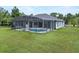 Expansive backyard featuring a screened pool, manicured lawn, and ample space for outdoor activities at 19232 Somerset St, Orlando, FL 32833