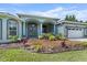 Stunning front exterior featuring a lush landscaped garden, double door entry, and an attached garage at 19232 Somerset St, Orlando, FL 32833