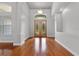 Elegant foyer boasts gleaming hardwood floors, stylish lighting, and a welcoming atmosphere at 19232 Somerset St, Orlando, FL 32833