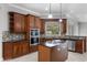 Gourmet kitchen features custom cabinets, stainless steel appliances, granite countertops and center island at 19232 Somerset St, Orlando, FL 32833