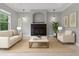 Relaxing living room offering a cozy fireplace, comfortable seating, and natural light from the window at 19232 Somerset St, Orlando, FL 32833