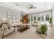 Stylish living room with plenty of seating, with an open view to the kitchen and the backyard through french doors at 19232 Somerset St, Orlando, FL 32833