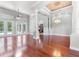 Open-concept living area with hardwood floors, high ceilings, elegant pillars, and glass doors at 19232 Somerset St, Orlando, FL 32833